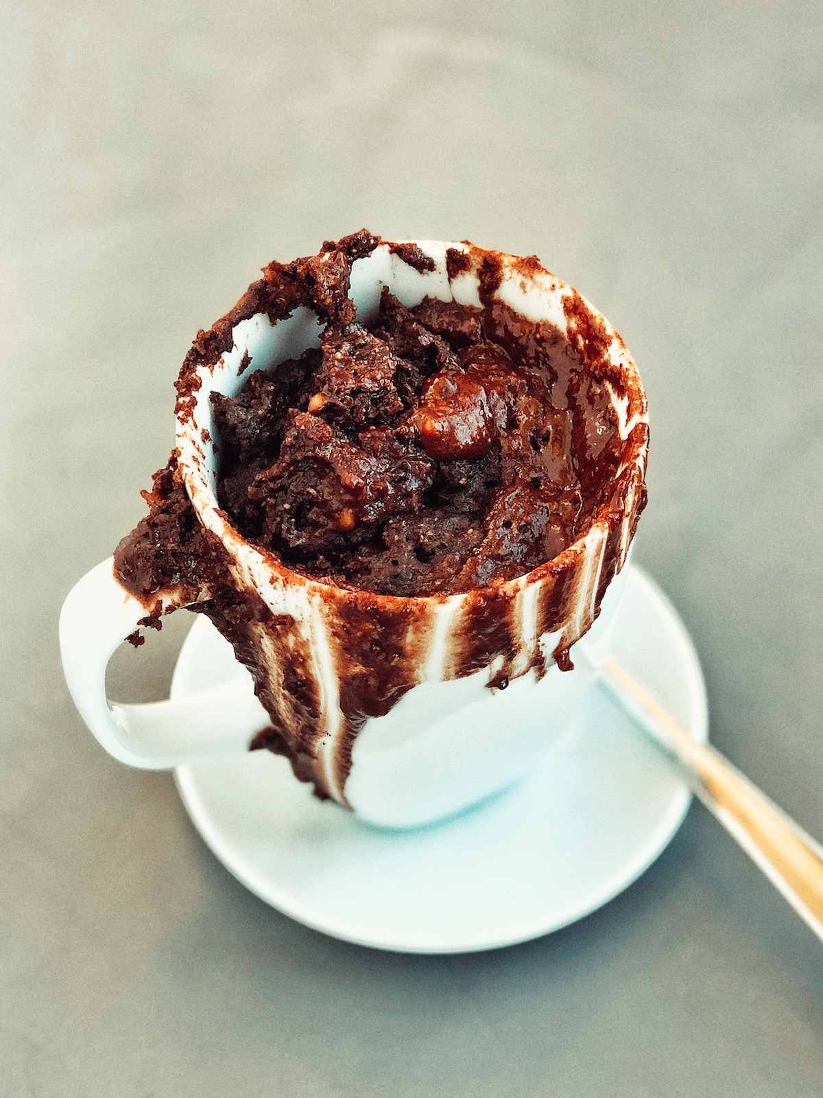 Chocolate Almondbutter Mugcake in white mug, grey background