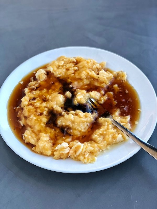 Mashed bananas and maple syrup on a white plate
